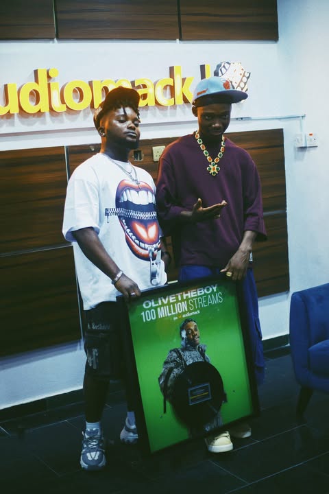 Olivetheboy Receives Plaque For Surpassing 100 Million Streams On Audiomack