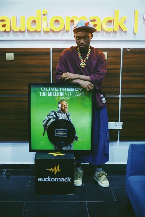 Olivetheboy Receives Plaque For Surpassing 100 Million Streams On Audiomack