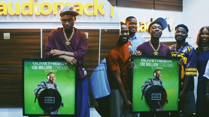 Olivetheboy Receives Plaque For Surpassing 100 Million Streams On Audiomack