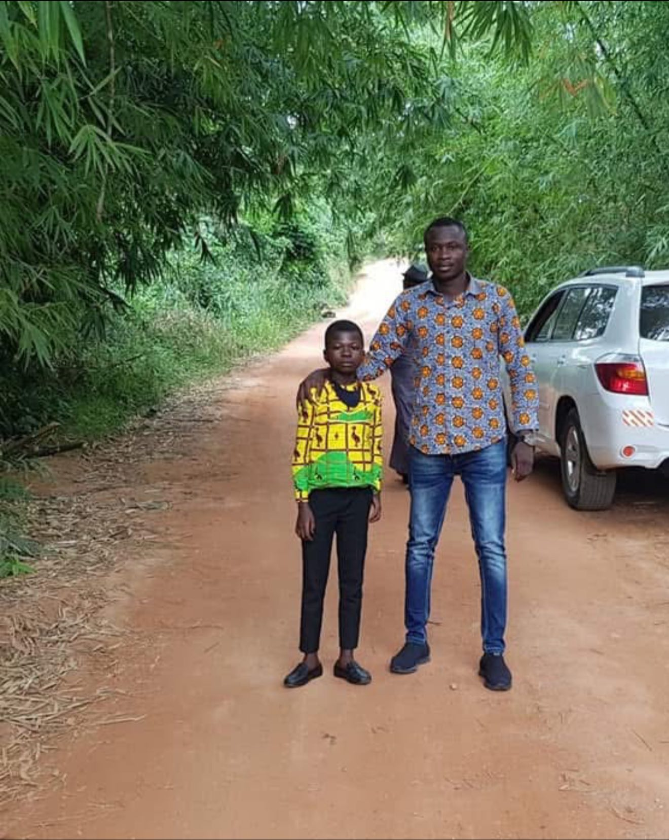 A heartwarming story of his adoptive son, Dominic Fobih, fondly known as “Professor,” and his remarkable journey from a remote town in Assin Kwamoabeng to becoming one of the best students at a school in Accra has been told by media personality and sports broadcaster Saddick Adams. Saddick Adams described how he first met Dominic in July 2020 after watching a video of the 9-year-old youngster promoting sports on a WhatsApp group. His Facebook post has subsequently sparked feelings and appreciation on social media. “Sometimes random people will see me at a funeral or shopping mall and ask, “where is that your small boy”. Police will stop me at a checkpoint and ask, “where’s that your boy”…. Well… Back to July 2020. I saw on a WhatsApp group page, a 9-year-old boy presenting sports. I instantly believed was destined for greatness. I enquired on his whereabouts. He was in a village of Assin Kwamoabeng. I asked that he be brought to Accra on my sports show. He was so good Dr Kwaku Oteng watched and suggested if I could drive to his village the next day to ask his parents to allow the boy move to Accra to live with me and school under his sponsorship. The drive to the village and the curcumstances of the village meant that what I had thought were struggles of my childhood was instead luxury. No motorable road, no electricity, no mobile network, no television and less than five mud houses. He had just completed stage six and was the best student in the village. The JHS was miles away from his village so like their dad, most of his nine siblings ended up as hunters & farmers, after class six. Because the daily trek to the next two towns to pursue upper primary education was an obstacle. But this boy was coming to the city of Accra. The parents allowed and he came with us. The real challenge was getting a quality school in Accra. The boy was naturally smart but the level of education in the small village of Assin Kwamoabeng Primary meant he was miles apart with his peers in the city. Some of the schools demanded entrance exams. Most of the questions were things he had never been taught or read before in his life. In the end, they can’t admit him and those that would admit him on condition he’s moved further lower in class. One of the best schools in Accra saw beyond his patent defects and admitted him. The beginning was tough but with encouragement and extra work, he gradually caught up. He had never seen a computer before when be came but in few years, he was leading coding sessions in class. Yesterday, he graduated, receiving one of the top student awards. Ladies and Gentlemen, “Professor” Dominic Fobih is a graduate and a computer shark.